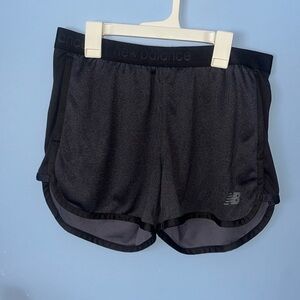 Dark gray with black accents, new balance, athletic shorts